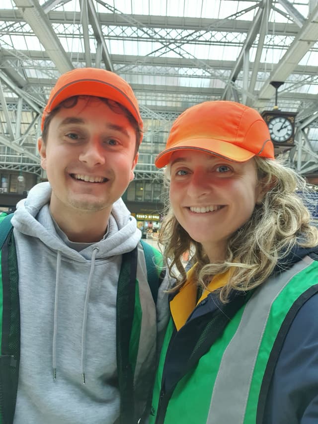 Hannah and Eliot in high-vis gear at Glasgow Central Station